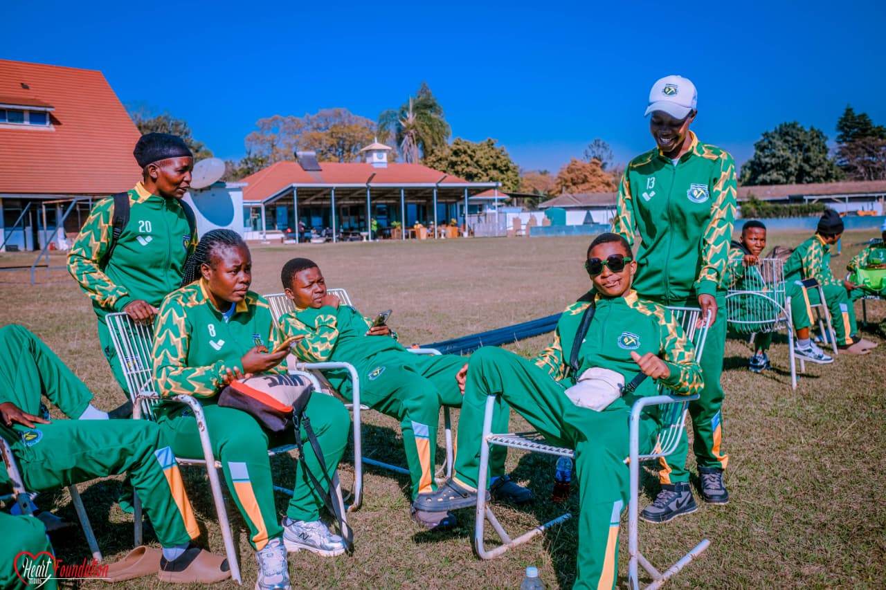 Squad members relaxing on a lawn outside a pavilion
